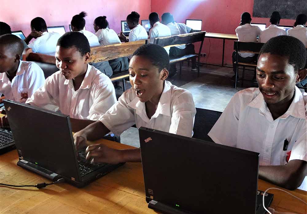 Students working on computers provided by the Turing Trust
