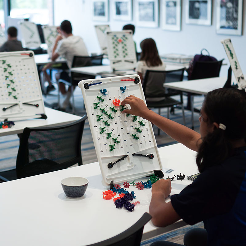 girl playing Turing Tumble in classroom setting